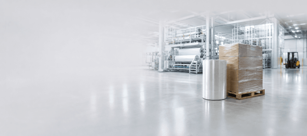Stretch film rolls and industrial packaging in a modern warehouse