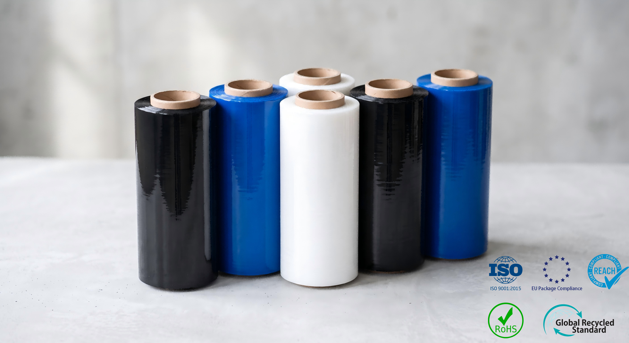 Black, blue, green, red and yellow colored stretch film rolls