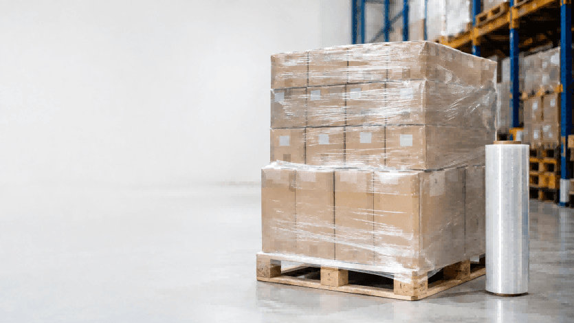 Pallet stretch film wrapped around cartons on a wooden pallet